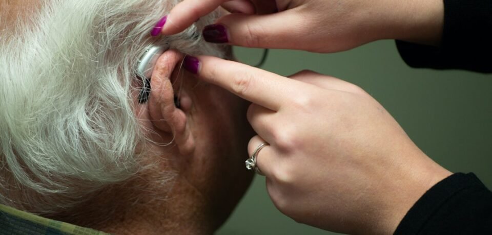 Audiologist preparing a patient for a hearing test