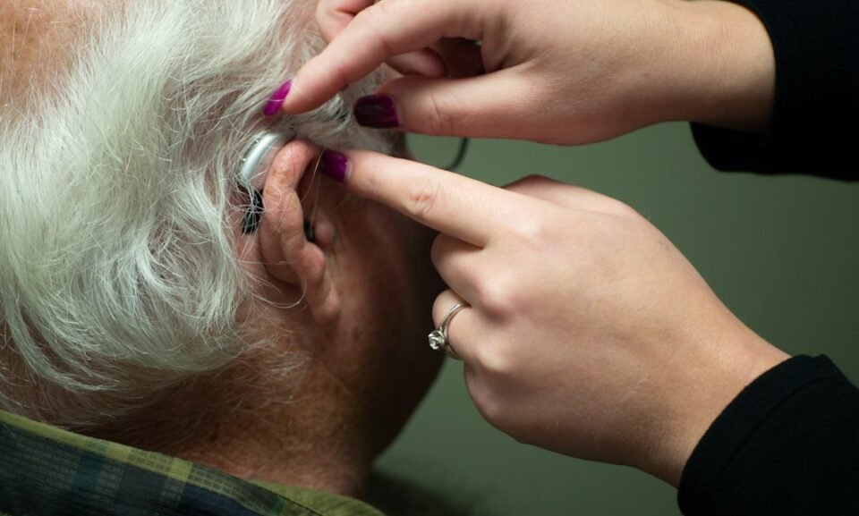 Audiologist preparing a patient for a hearing test